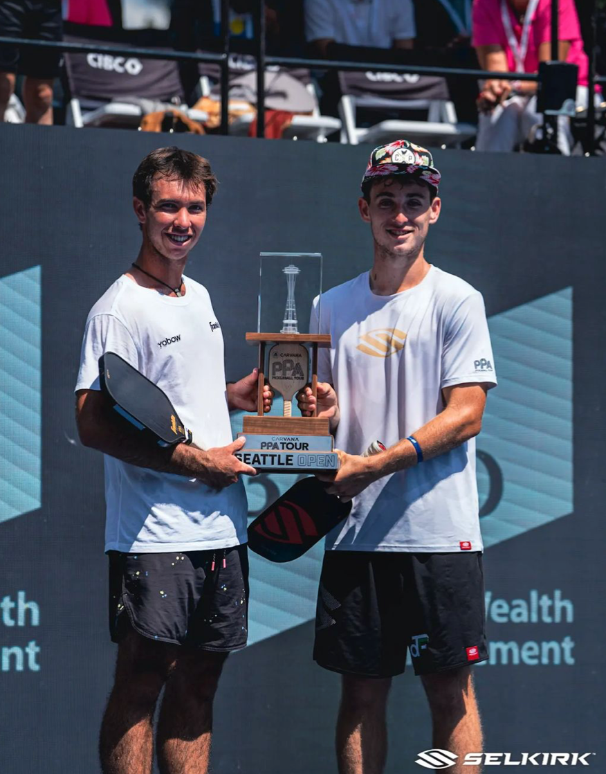 Two male players holding a trophy at the PPA Seattle Open.