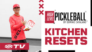 A player demonstrating a kitchen reset in pickleball, wearing a red shirt and holding a paddle. Text: 'HIGH LEVEL PICKLEBALL', 'KITCHEN RESETS'