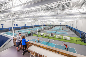 View of indoor pickleball courts at The Flying Pickle in Meridian, Idaho, with players in action.