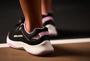 Close-up of black and pink Selkirk pickleball shoes with 'SELKIRK' branding.