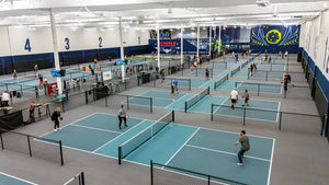 Aerial view of multiple pickleball courts with players in action