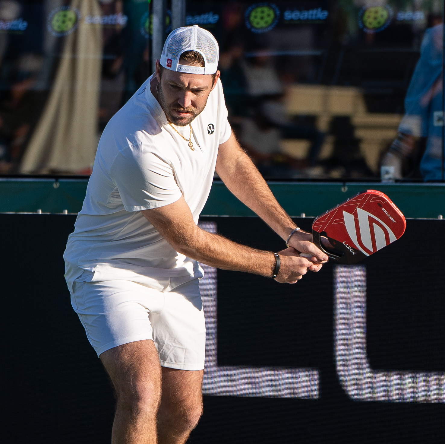 Action shot of Jack Sock with clickable dots to shop the products they are using and wearing.