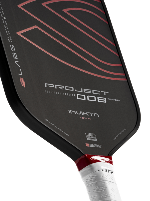 Selkirk LABS Project 008 13mm Invikta pickleball paddle with black surface and red handle.