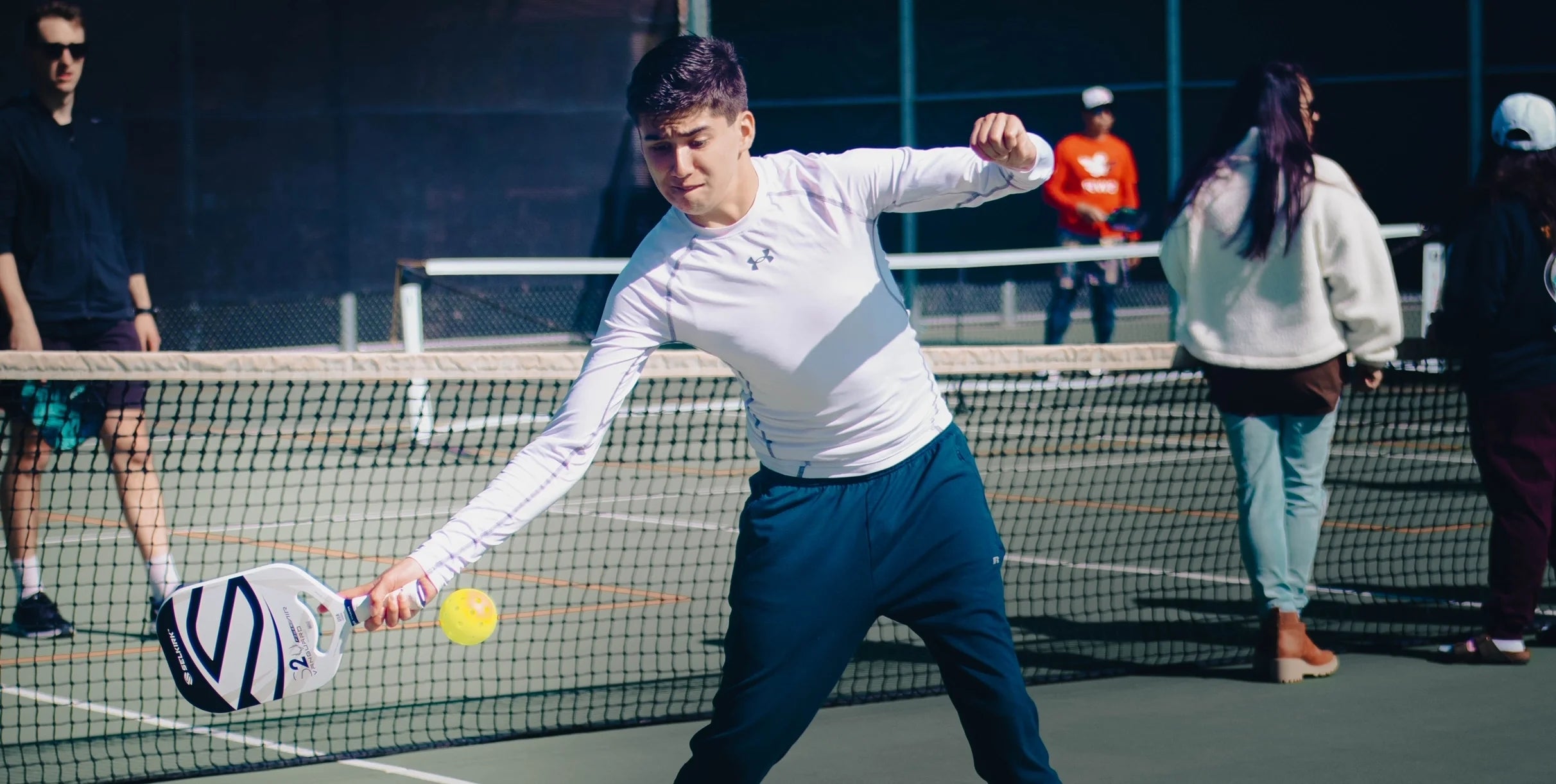 Raymond Carrion playing pickleball on a court, demonstrating his skills