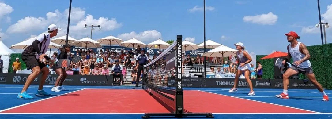 Players competing in a pickleball match at the PPA Championship, with spectators in the background.