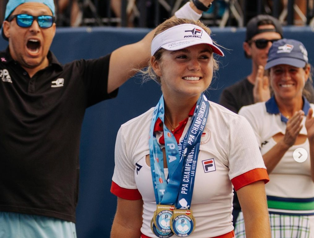 Female athlete celebrating with medals at a pickleball tournament
