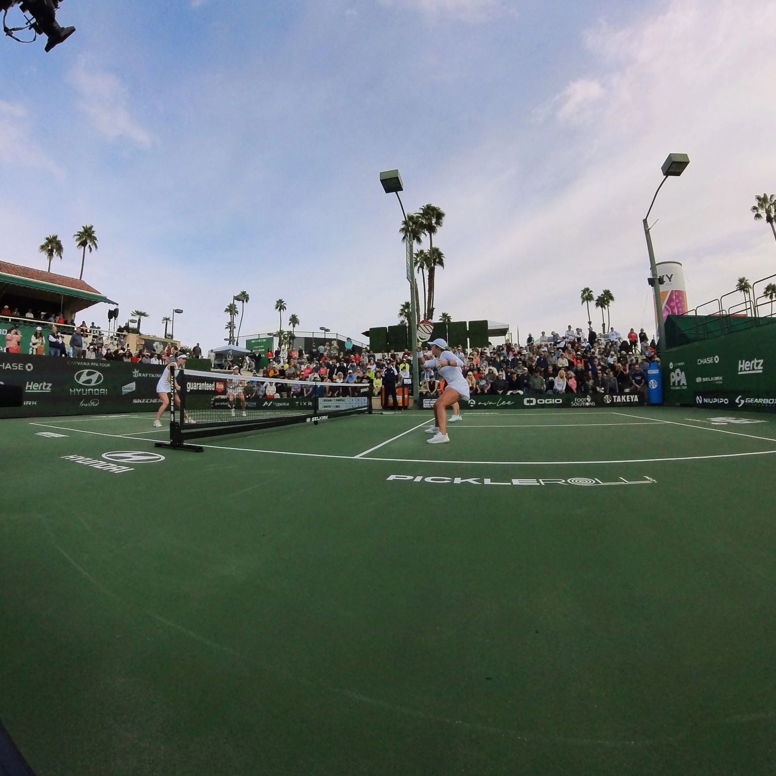 A pickleball match at the 2023 PPA Masters with players and a large crowd.