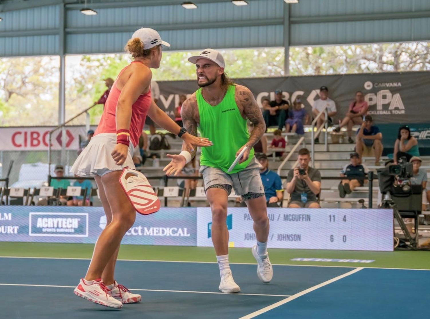 Tyson McGuffin and Catherine Parenteau celebrating during a match at the PPA Florida Open.