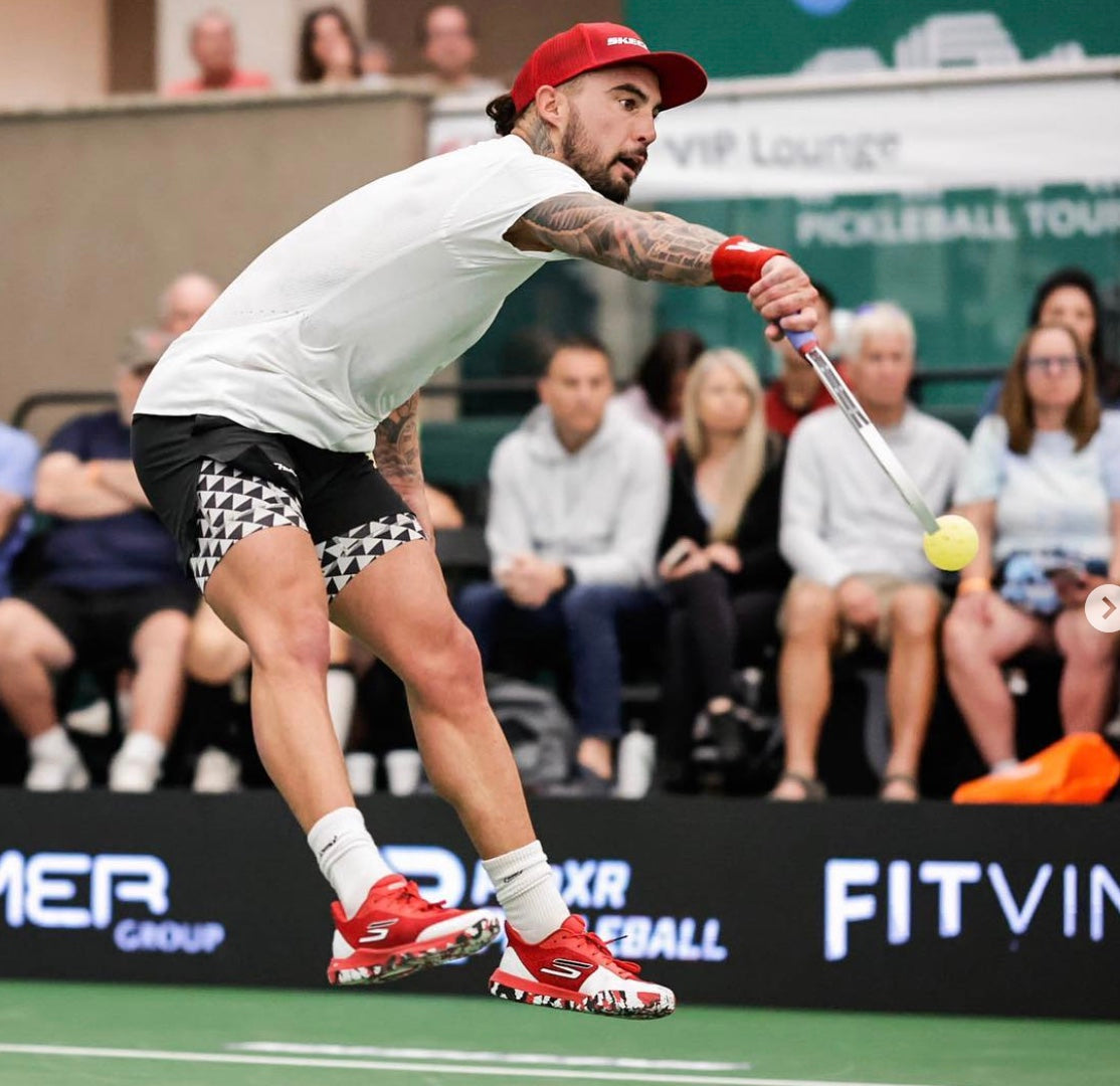 Jack Sock hitting a pickleball during a match at the PPA Tour North Carolina Open