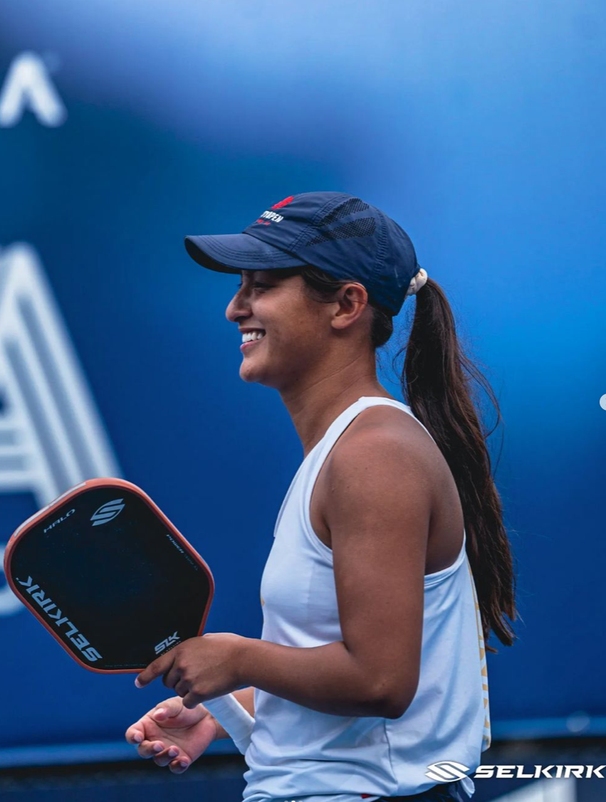 A player smiling while holding a pickleball paddle at the PPA Seattle Open.