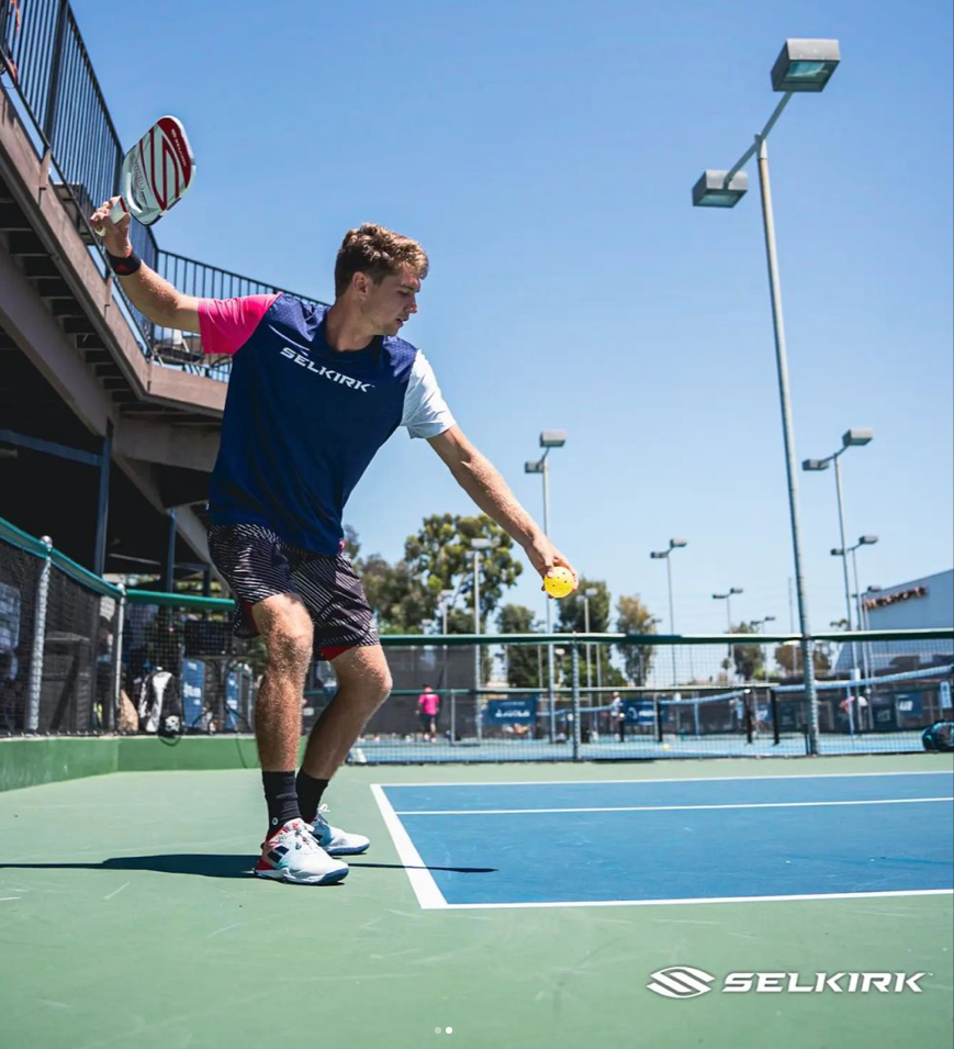 Player preparing to hit a pickleball shot on the court