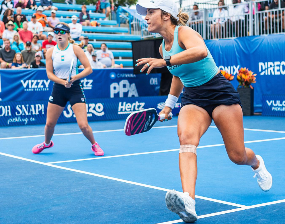 A player in action during a pickleball match at the PPA Cincinnati tournament, with another player in the background.