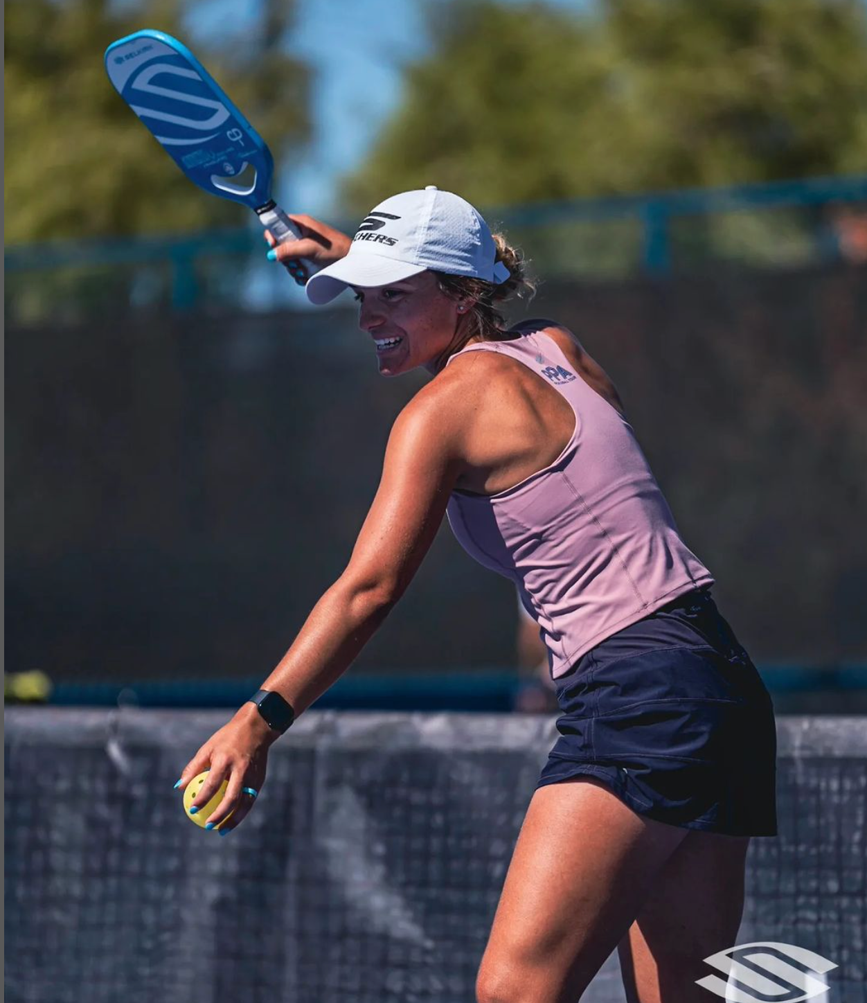 Female player serving with a paddle during a match at PPA Las Vegas