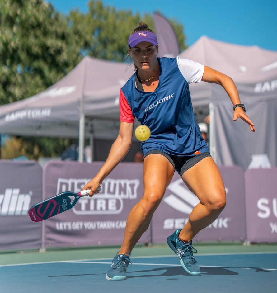 Judit Castillo playing pickleball, wearing a Selkirk jersey, preparing to hit a ball.