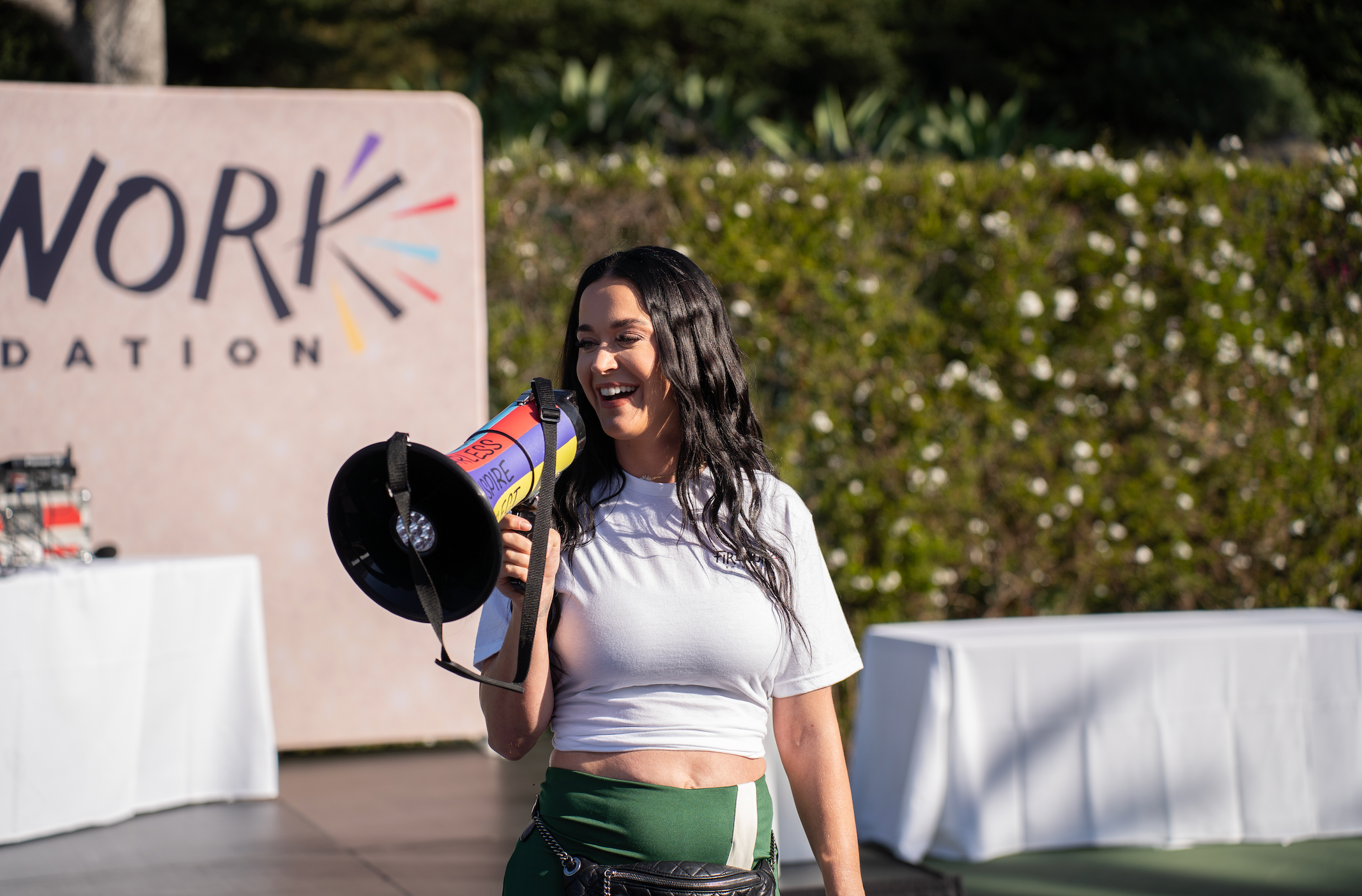 Katy Perry holding a megaphone at the Firework Foundation event