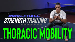 A man demonstrating thoracic mobility exercises with a kettlebell on a pickleball court.