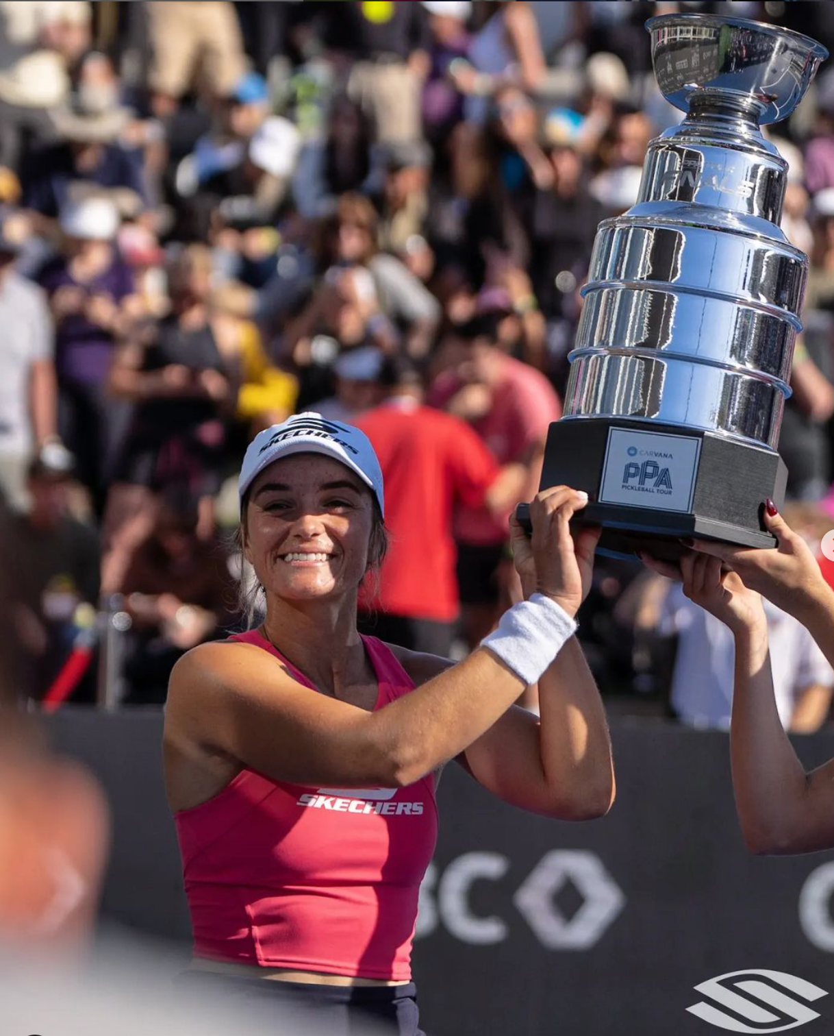 Catherine Parenteau celebrating with the championship trophy after winning gold.