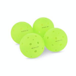 Front view of four neon green Selkirk pickleballs showcasing perforated surfaces on a white background