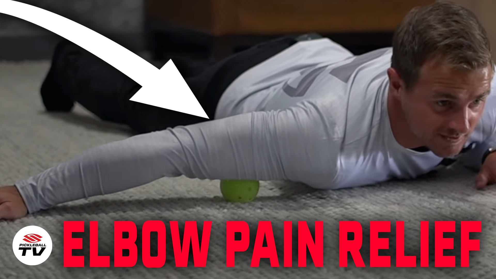 Man lying on stomach using a pickleball under his arm for elbow pain relief, with text 'ELBOW PAIN RELIEF'
