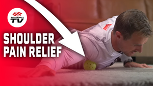 A person lying on their stomach using a pickleball to relieve shoulder pain, with text 'SHOULDER PAIN RELIEF' and an arrow pointing to the pickleball.