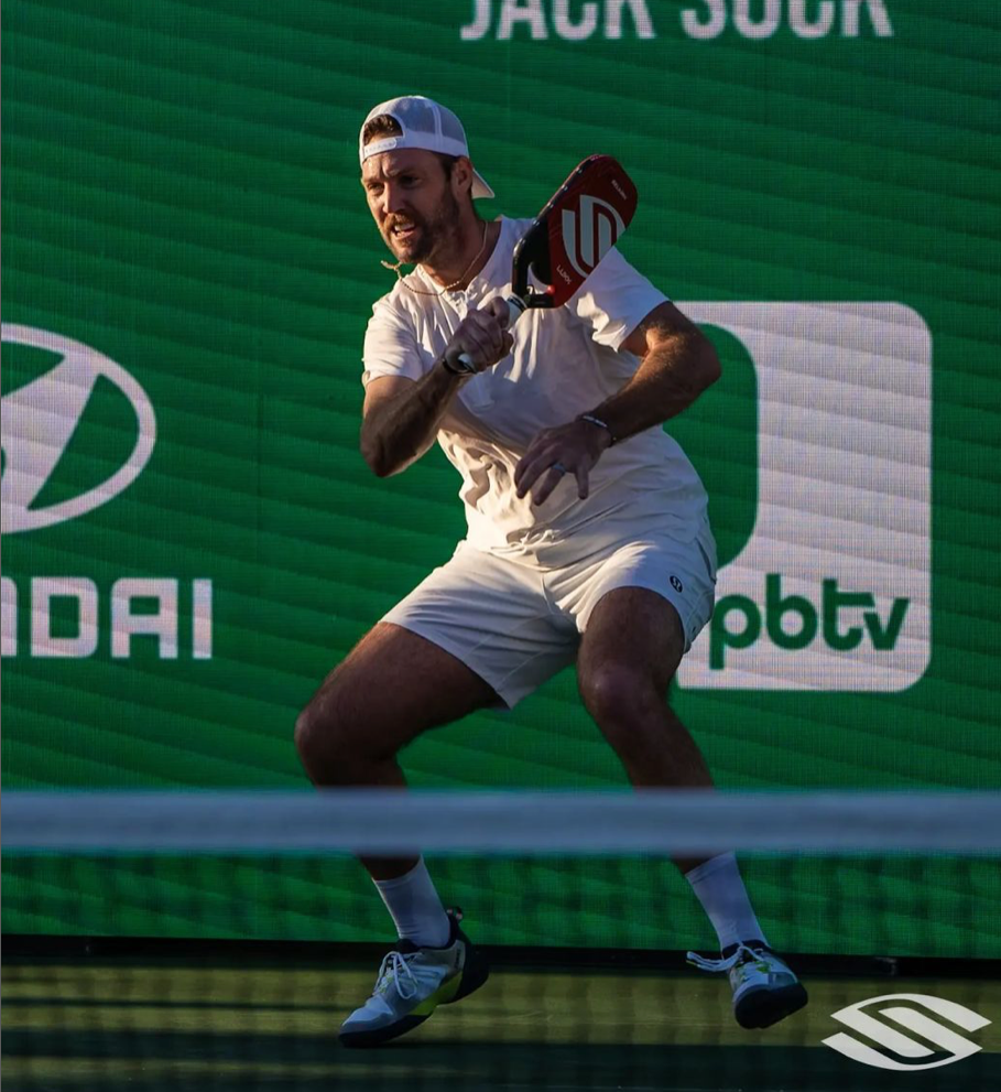 Jack Sock preparing to hit a pickleball shot during the Masters tournament