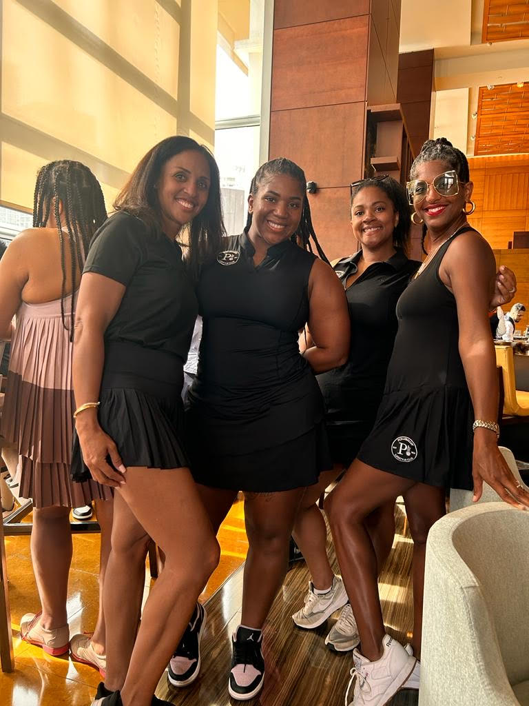 Four women in black pickleball attire posing together, representing the PickleBallin’ Lifestyle Club.