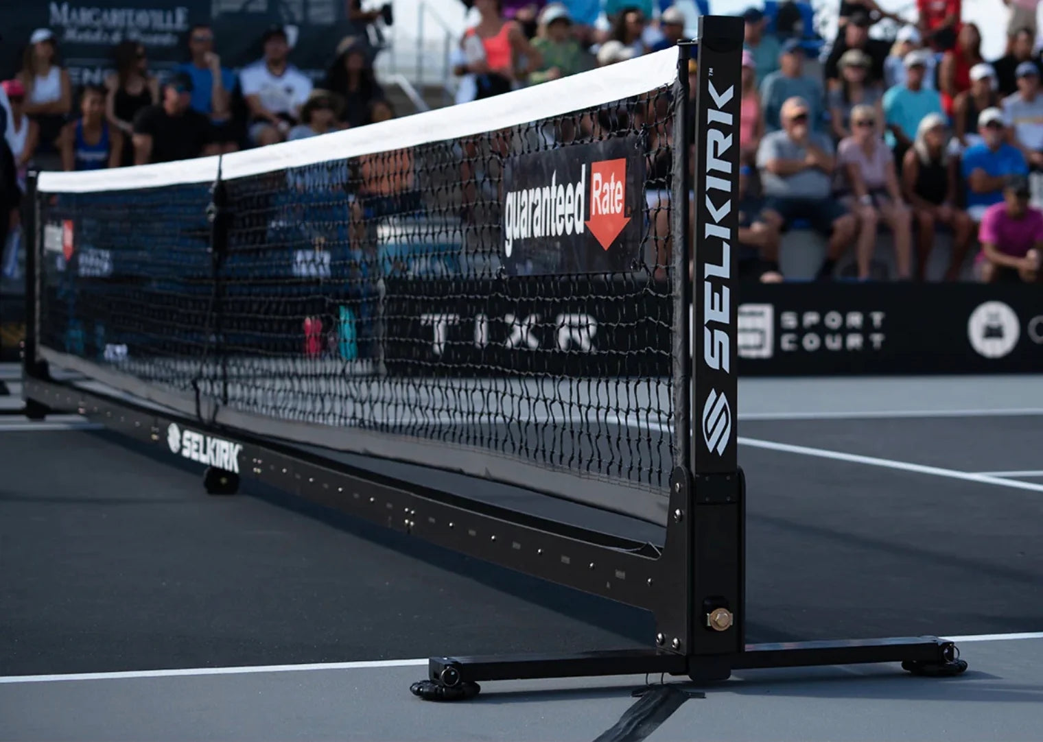Selkirk paddle net with visible branding and sponsorship logos