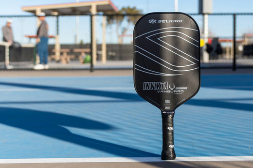 Selkirk VANGUARD Control pickleball paddle standing on a court