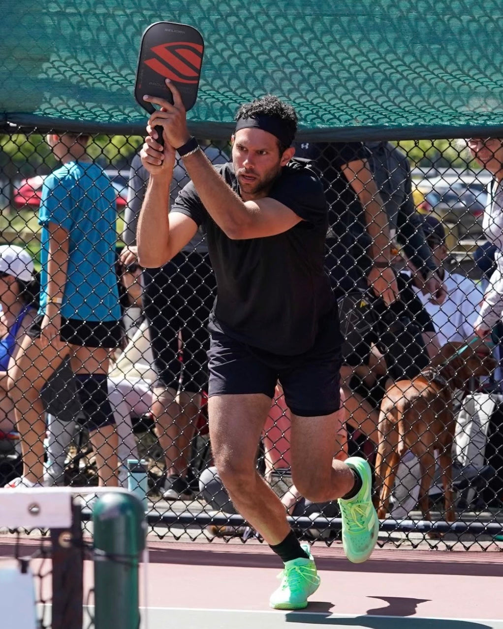 Ben Grant playing pickleball, focused on his game with a paddle.