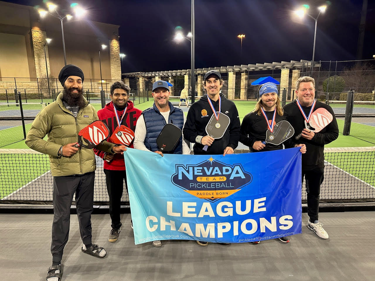 Nevada Team Pickleball League Champions holding a banner