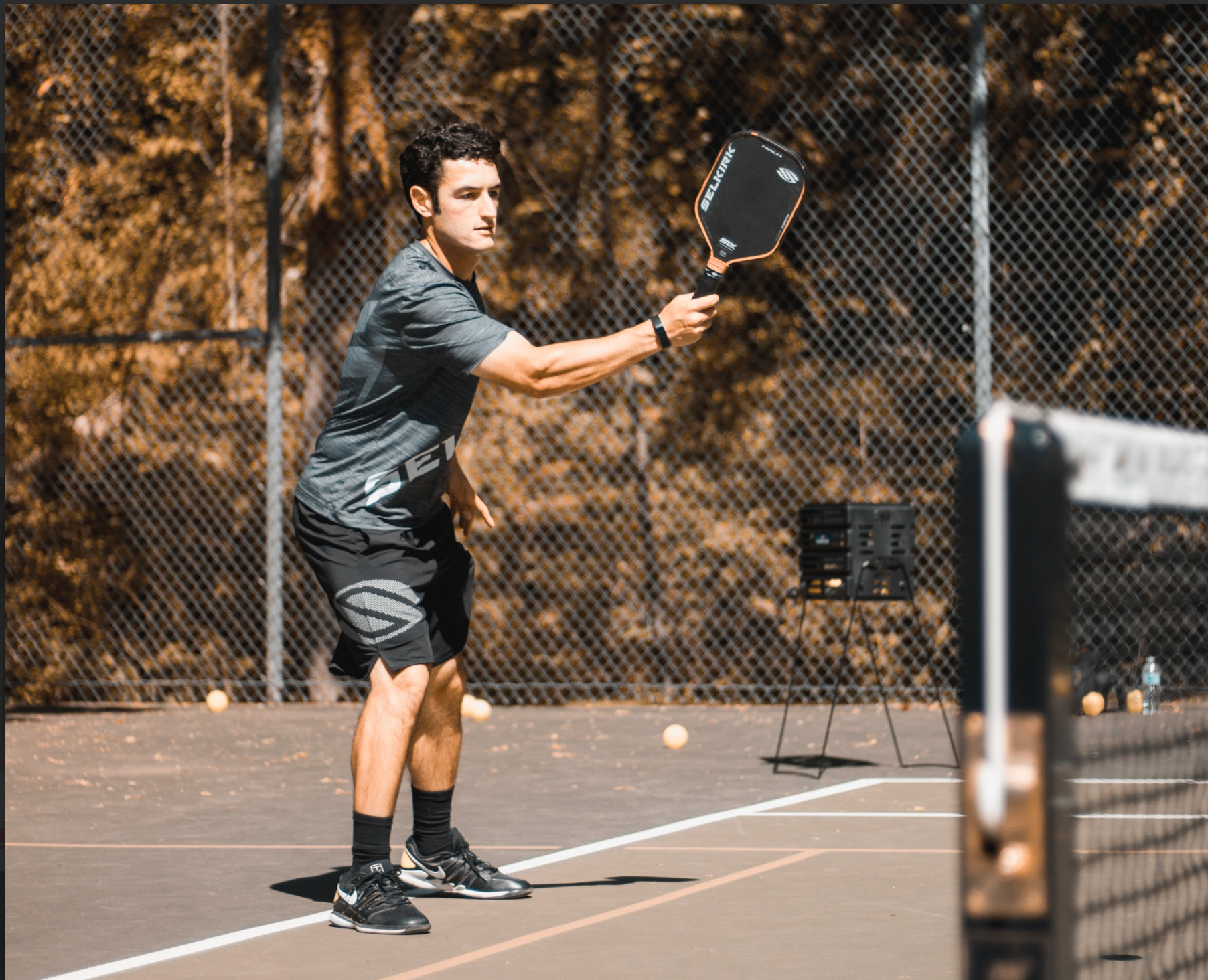 Noah Zwiren preparing to serve on a pickleball court