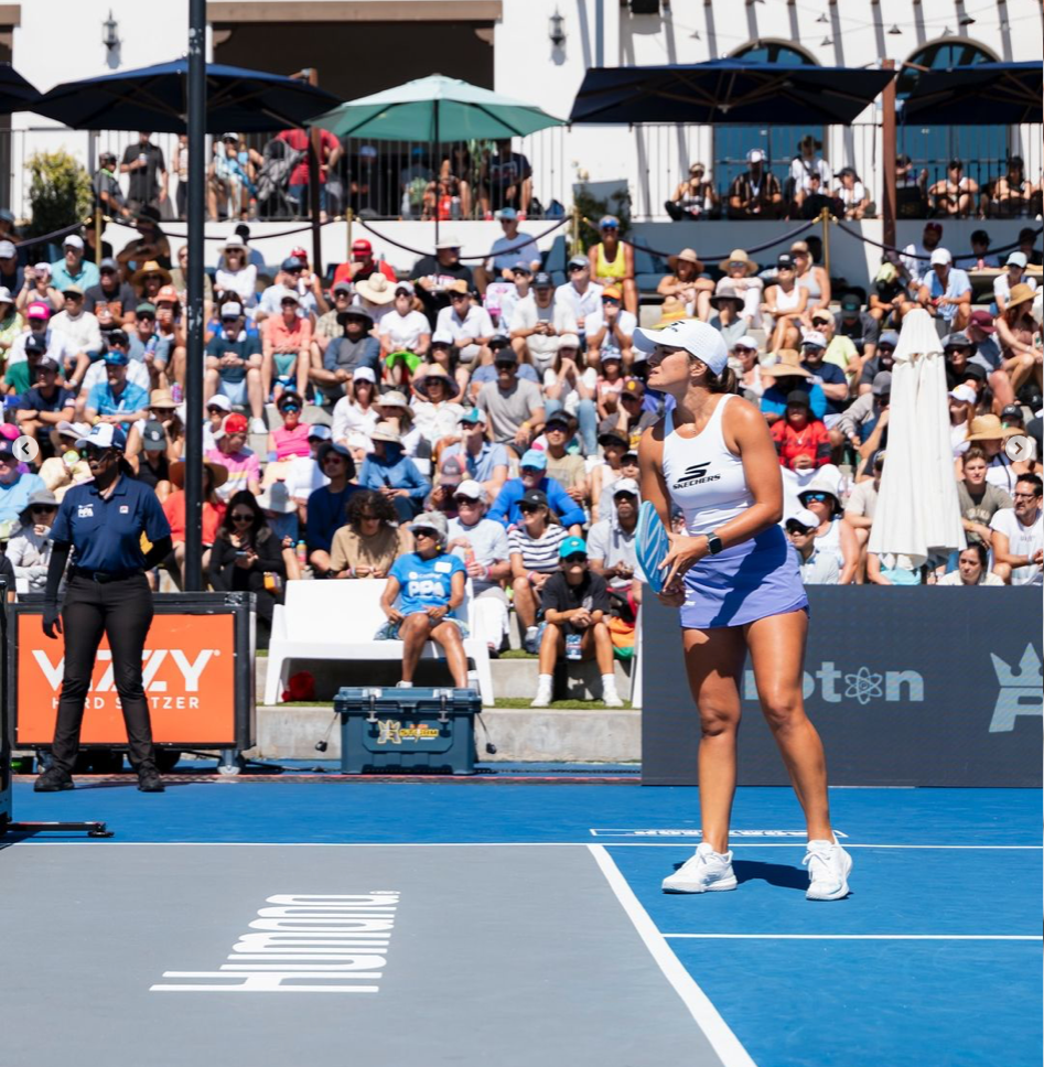 Catherine Parenteau prepares to serve during a packed semifinal match at the California triple crown tournament.