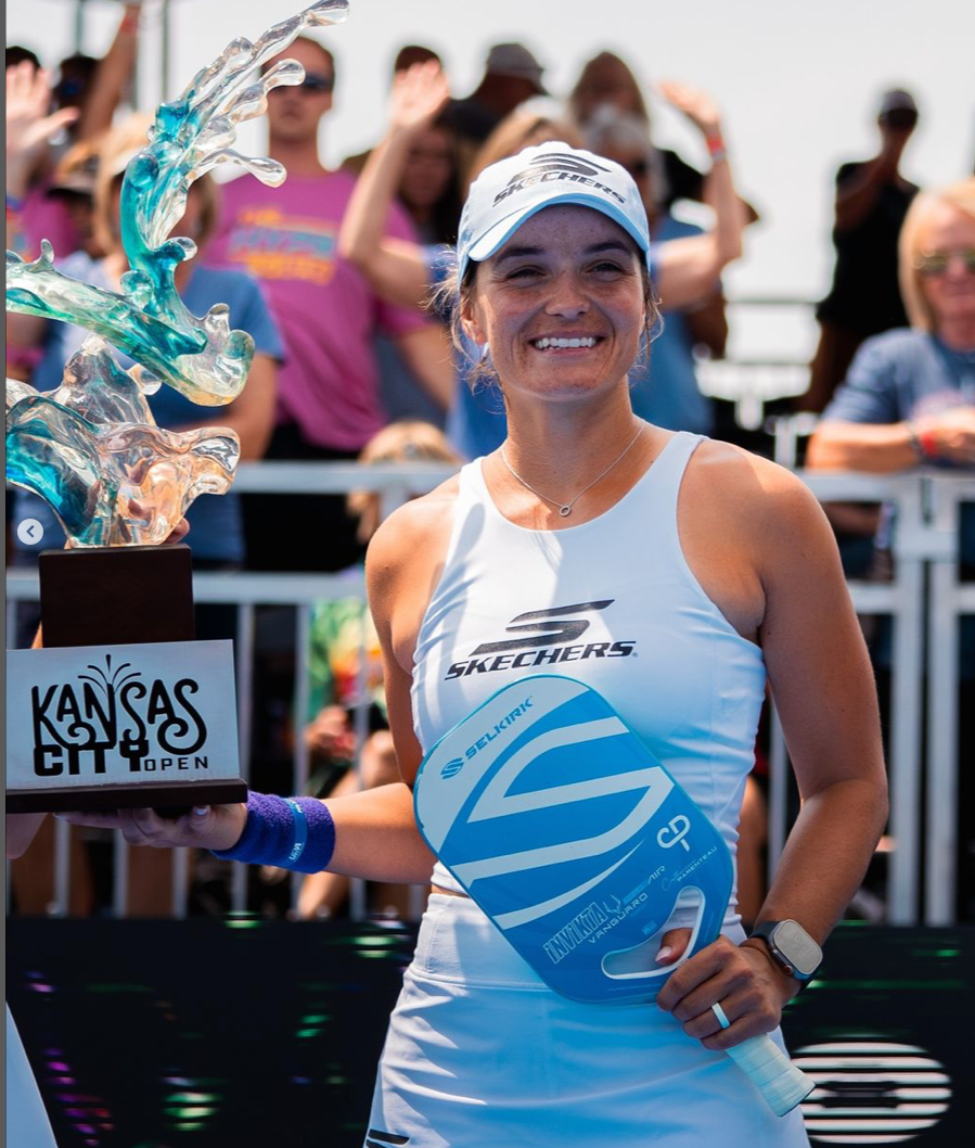 Parenteau holding a trophy and paddle at the Kansas City Open