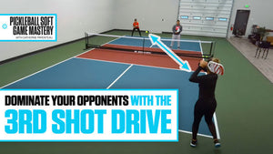 Catherine Parenteau demonstrates a third shot drive in pickleball, targeting two opponents. Text: 'DOMINATE YOUR OPPONENTS WITH THE 3RD SHOT DRIVE.'