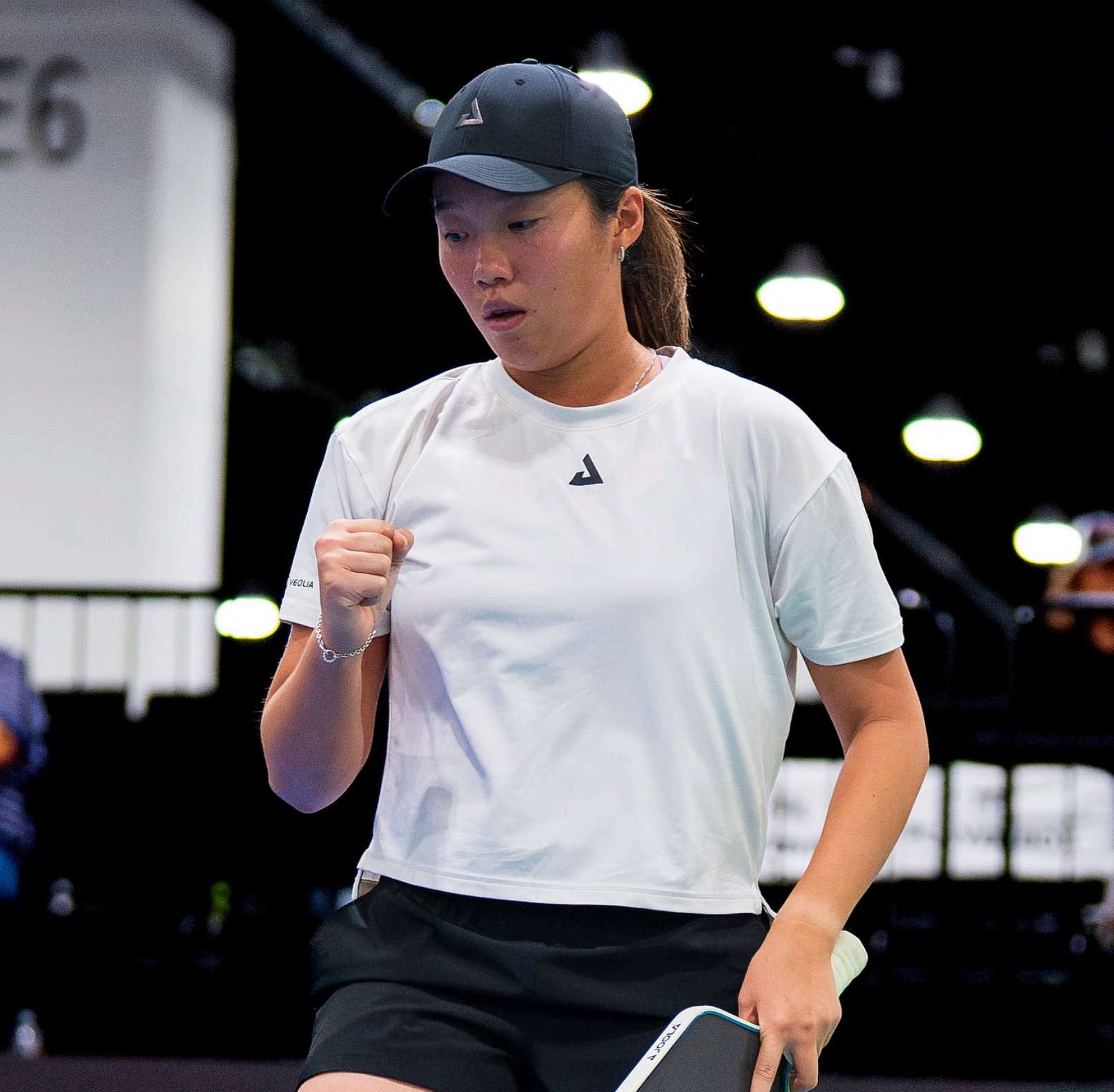 A female pickleball player celebrating a point during a match.