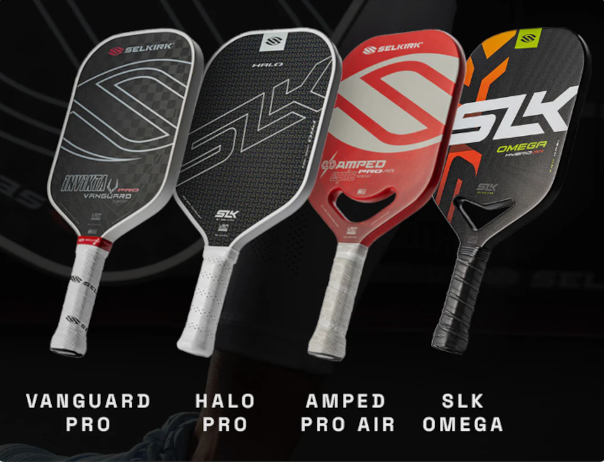 Angled view of four Selkirk pickleball paddles (Vanguard Pro, Halo Pro, Amped Pro Air, SLK Omega) showing faces and grips