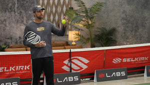 A man holding a pickleball and paddle, preparing to demonstrate techniques for a comeback in pickleball.