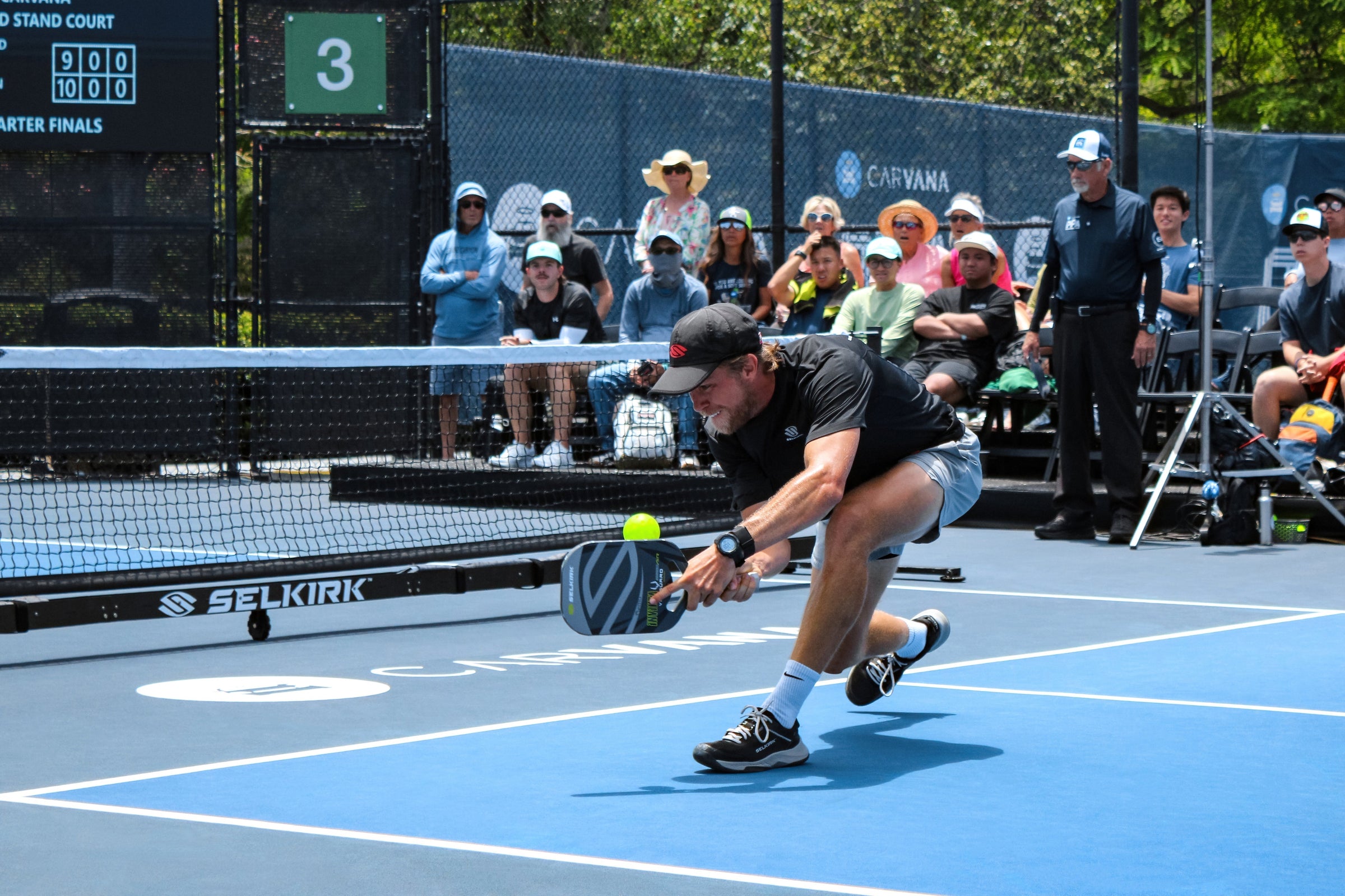 Pickleball player diving to return a ball at PPA Las Vegas with a Selkirk paddle, spectators behind the court