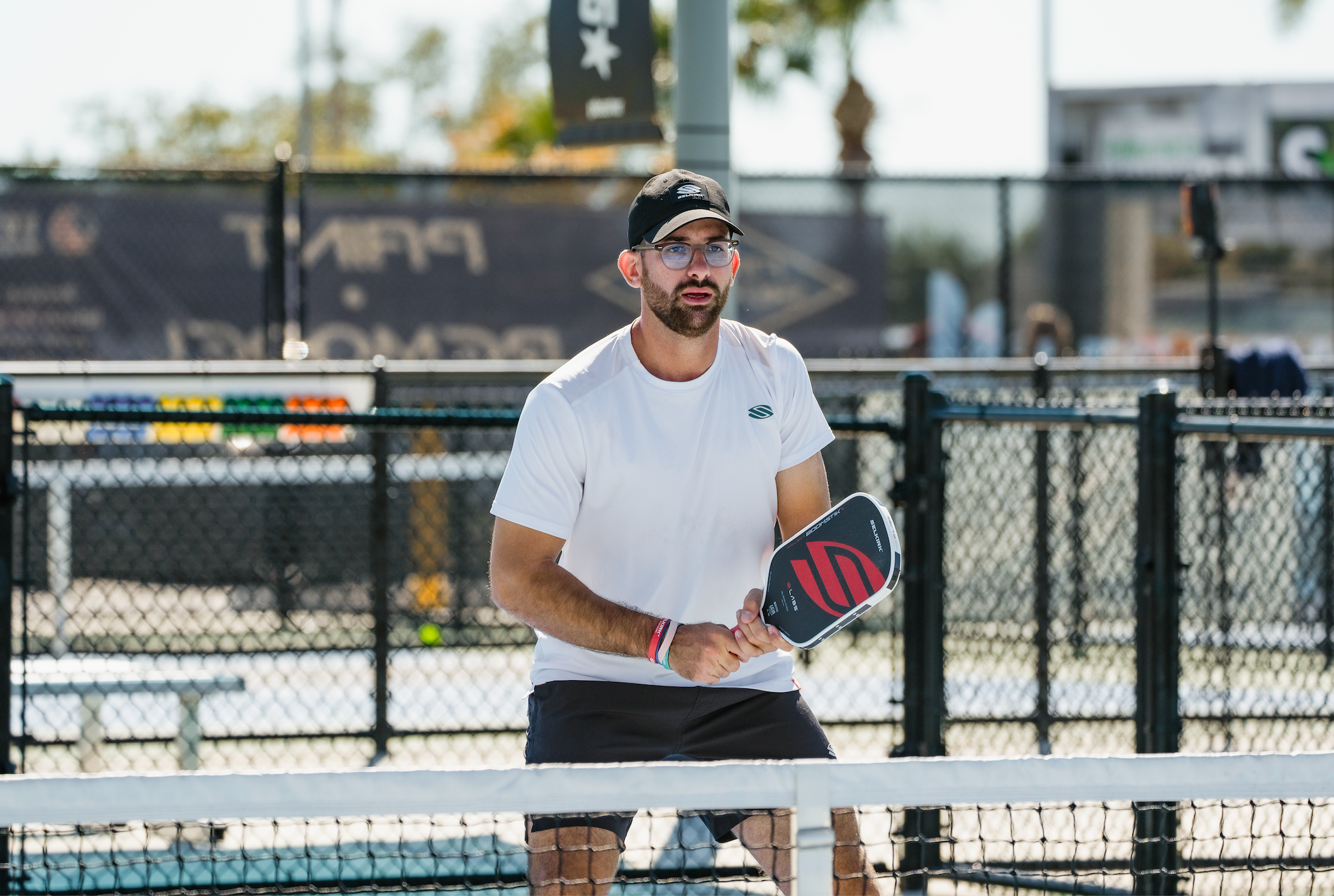 Selkirk Sparta pro Anouar Braham prepares to receive a shot on an outdoor pickleball court. 
