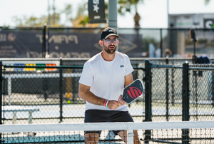 Selkirk Sparta pro Anouar Braham prepares to receive a shot on an outdoor pickleball court. 