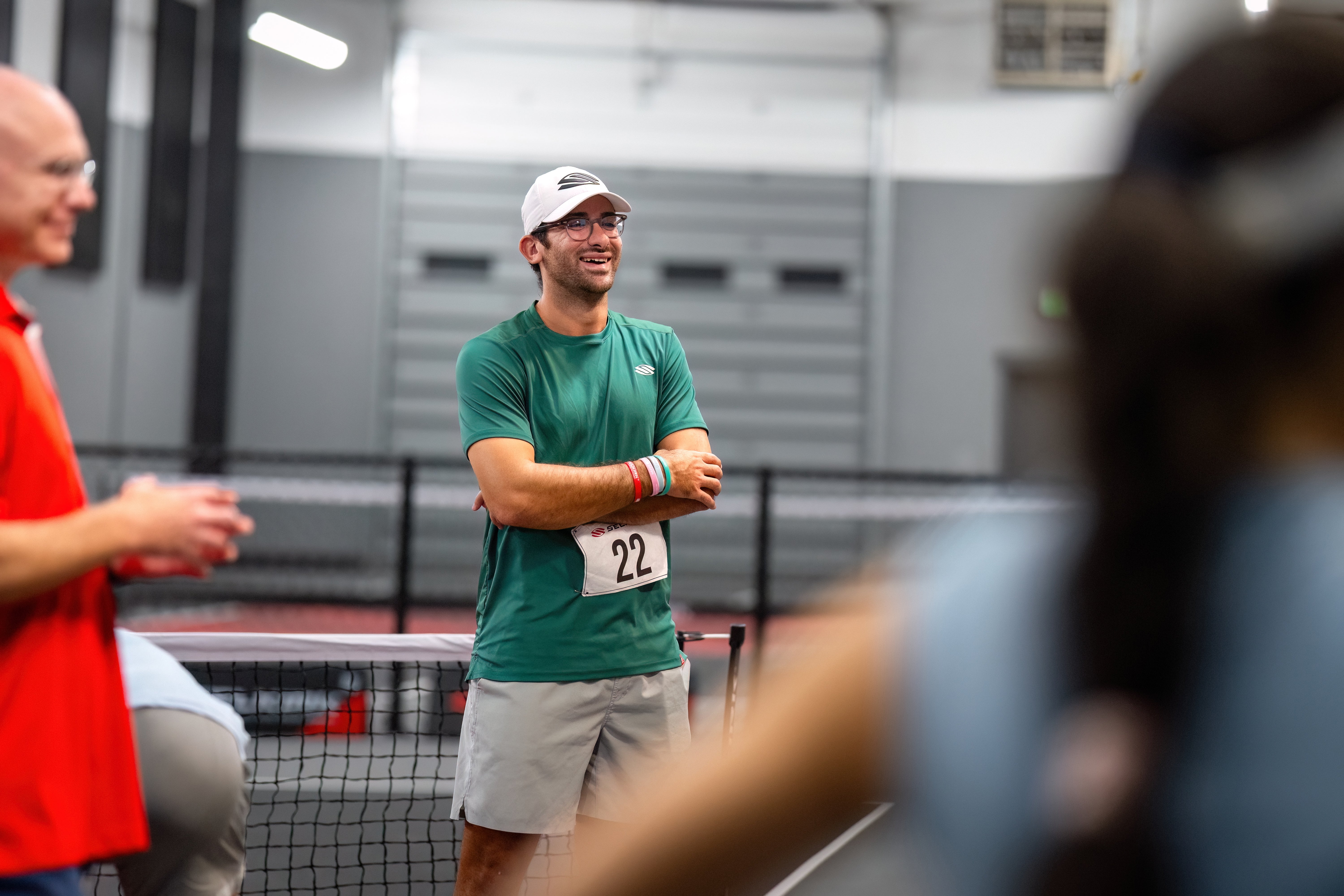 Anouar Braham smiles as he wears a number on his shirt to compete in the inaugural Selkirk Pickleball Combine. 