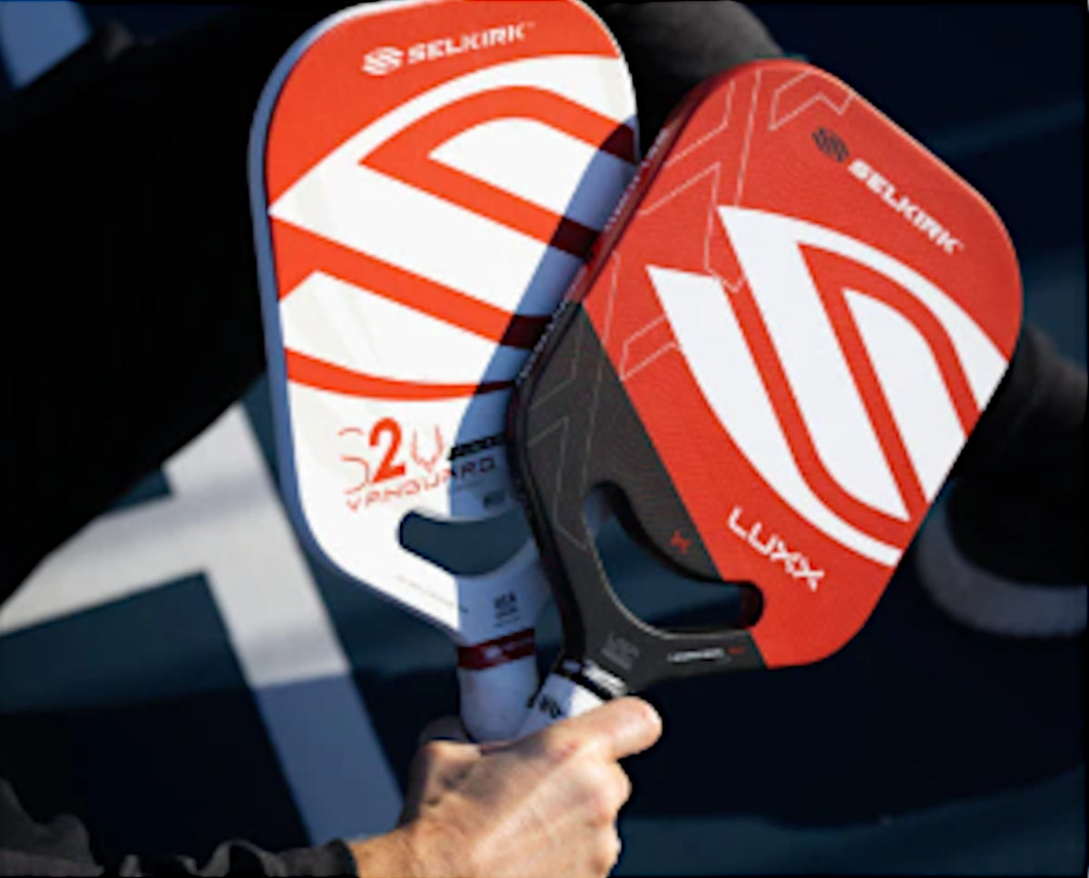 Two pickleball paddles: the Selkirk S2 Vanguard and Luxxa, showcasing their designs.