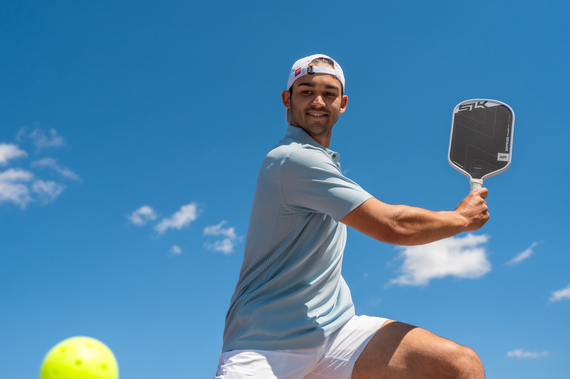 Cade Edwards smiles as he hits a backhand with his SLK ERA Power.