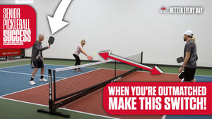 A team of senior players and a team of younger players dinking at the net on an indoor pickleball court. Text: 'WHEN YOU'RE OUTMATCHED MAKE THIS SWITCH!'