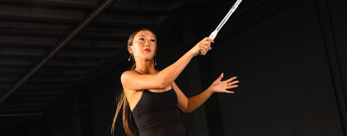 Kiora Kunimoto hits her serve