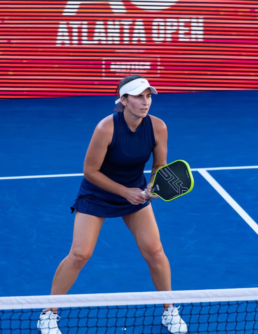 Female pickleball player preparing to serve during a match at the Atlanta Open.