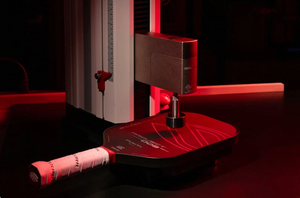 A Selkirk paddle rests inside a Universal Testing Machine in the Selkirk lab. 