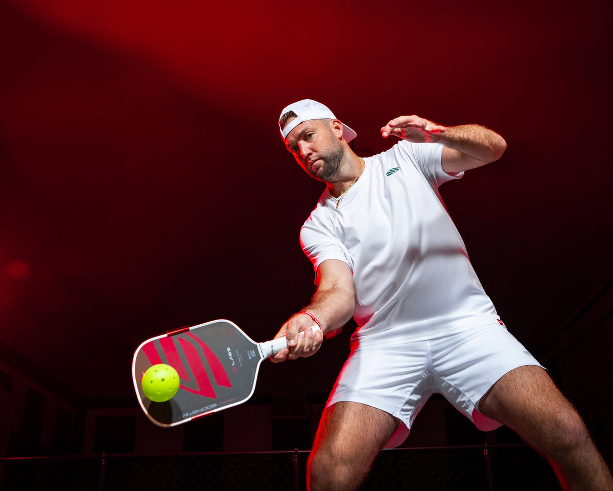 Jack Sock making contact with a pickleball swinging the Selkirk LABS Project Boomstik paddle