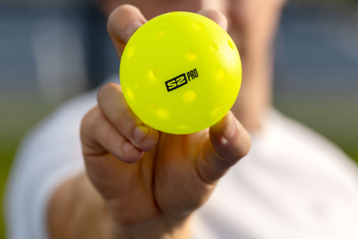 A close-up image shows a hand holding the Selkirk S2 Pro pickleball