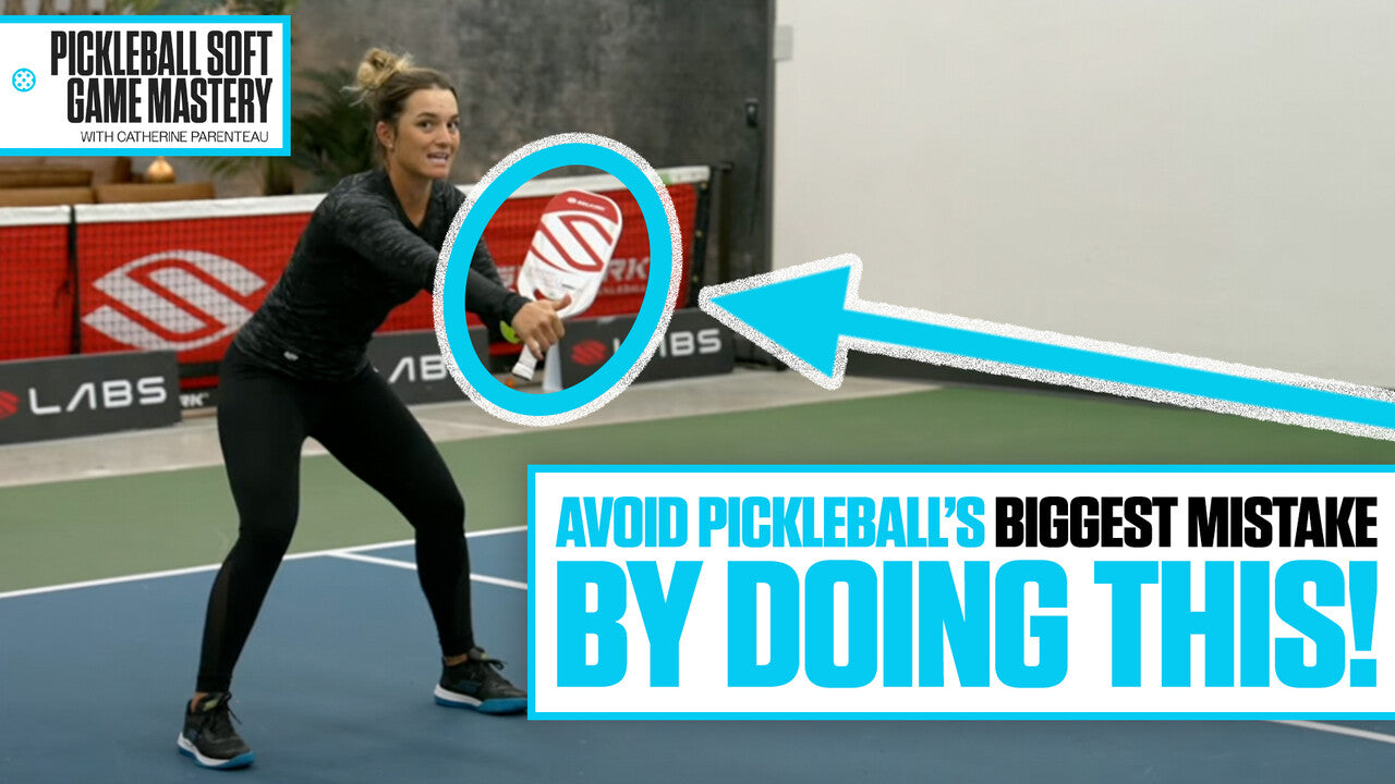 Catherine Parenteau demonstrates a low, squatted position in the transition zone, with text: 'Avoid Pickleball's Biggest Mistake By Doing This!'